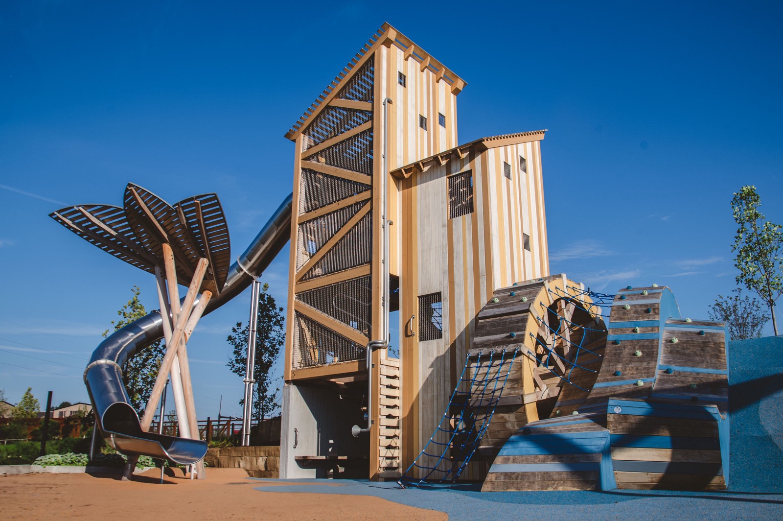 The Grist Mill Tower with slides and climbing structures at Gatton Park's Adventure Playground.