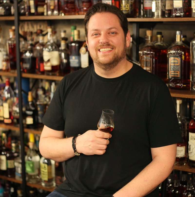 Kroger's Chris Blandford holding a glass of bourbon