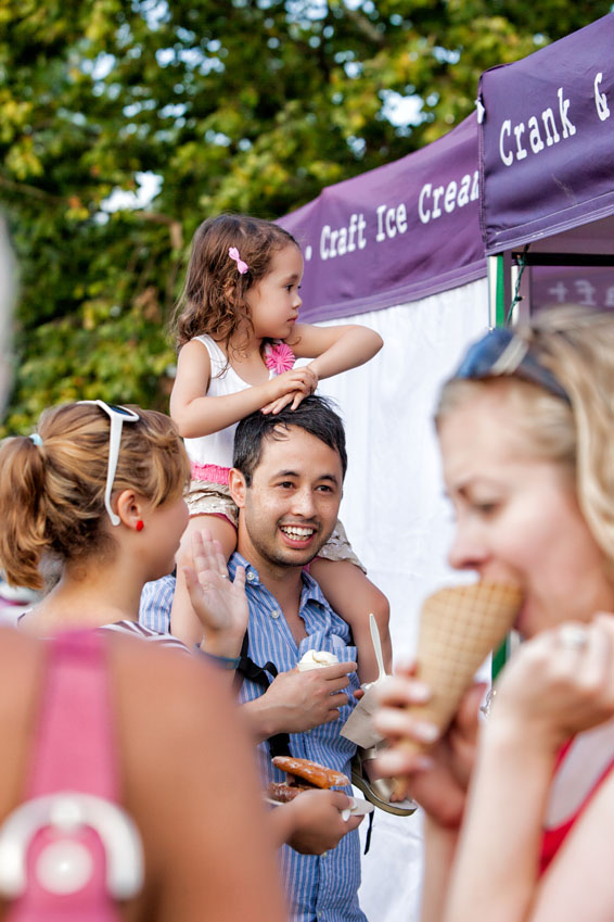 Father carrying daughter on shoulders at the festival