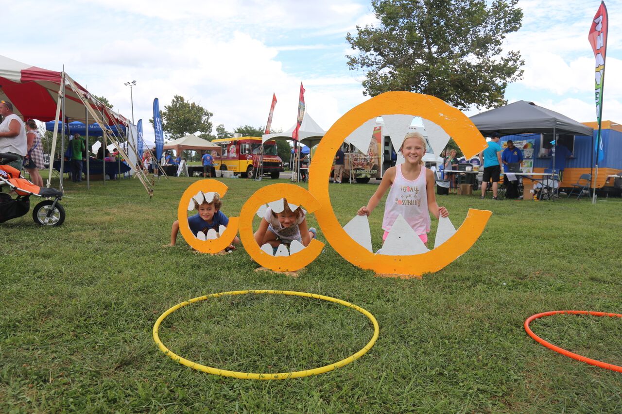 Kids enjoying hands-on activities in the Live Green Lexington zone.