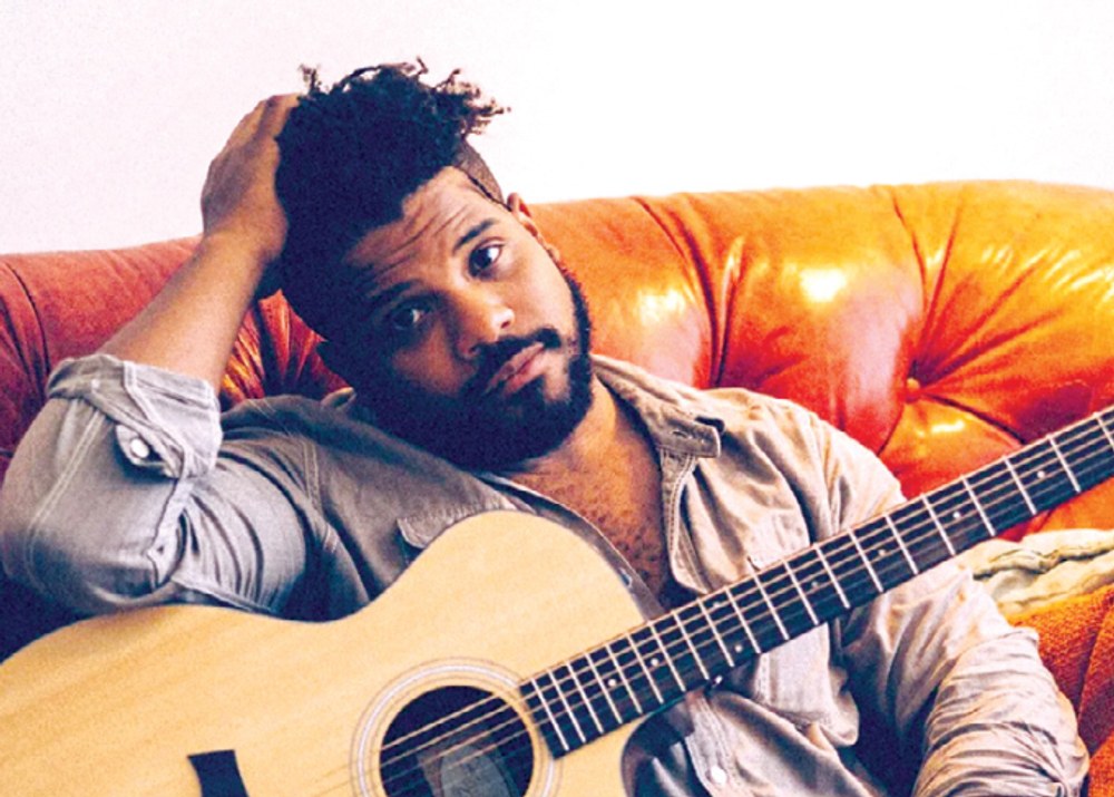 Singer-songwriter Scott T. Smith with his guitar.