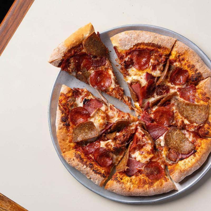 A pepperoni pizza on a metal pan from Joe Bologna's.